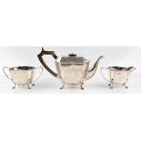 An Art Deco silver three piece tea set, comprising a teapot, sugar bowl and milk jug, hallmarked