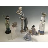 Three Nao figures, lady wearing hat and two girls with dogs, together with four Lladro figures,