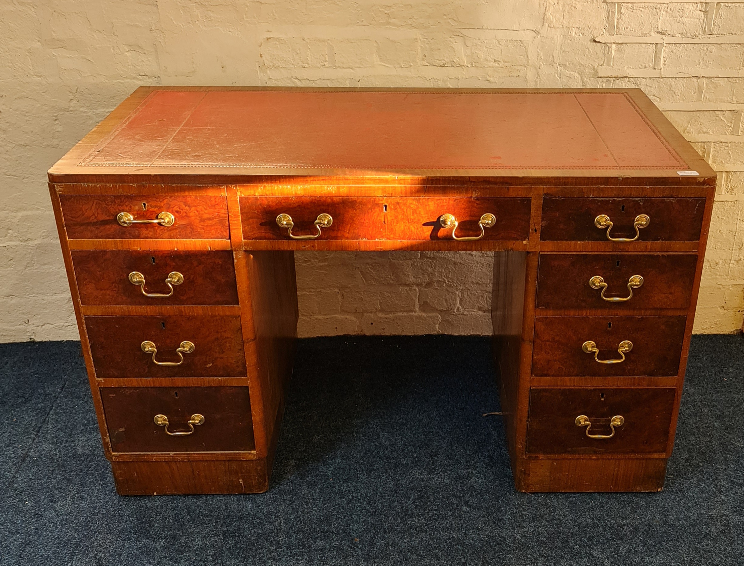 A walnut eight draw desk with red leather insert to top IMPORTANT: Online viewing and bidding