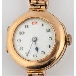 A hallmarked 9ct yellow gold ladies cocktail wrist watch, the white enamel dial having hourly Arabic