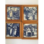 Four blue and white framed tiles, one Wedgwood girl with wolf, together with three Mintons William