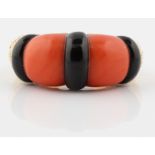 A PIAGET coral and black hardstone dress ring, set with two panels of coral and three panels of