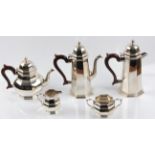 A silver five piece tea set, comprising two coffee pots, a teapot, a sugar bowl and milk jug, all of