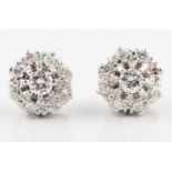 A pair of 18ct white and yellow gold diamond cluster earrings, each earring set with a principal