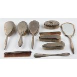 A hallmarked silver backed dressing table set, comprising two hair brushes, two clothes brushes