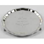 A hallmarked silver card tray with personal engraving to centre, raised on three scroll feet,