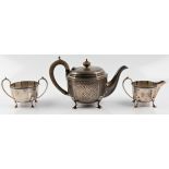 An Art Deco three piece silver tea set, comprising a teapot, milk jug and sugar bowl, teapot