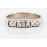 A seven stone diamond ring, set with seven round brilliant cut diamonds, total diamond weight