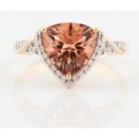 A hallmarked 18ct yellow gold morganite and diamond dress ring, set with a triangular cut morganite