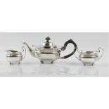 A hallmarked silver three piece bachelor tea set, comprising a tea pot, sugar bowl and milk jug,