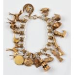 A fancy link bracelet, suspending approx. 18 various charms, including a Shakespeare bust, a deer, a