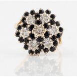 A hallmarked 9ct yellow gold sapphire and diamond dress ring, set with clusters of round cut