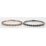 A pair of diamond set bangles, one bangle set with approx. 38 round brilliant cut pinkish brown