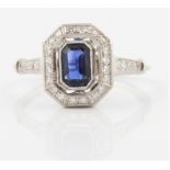 A hallmarked 9ct white gold sapphire and diamond Art Deco style ring, set with an emerald cut