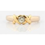 A hallmarked 18ct white and yellow gold diamond solitaire ring, set with a round brilliant cut