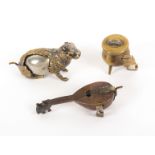 Three metal novelty tape measures, comprising a seated squirrel, reduced tape wound from the tail,