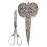 An 18th Century silver filigree scissor case with a pair of silver mounted scissors, the filigree