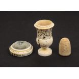 An early 19th Century ivory vase form thimble case/pin cushion complete with thimble, painted in