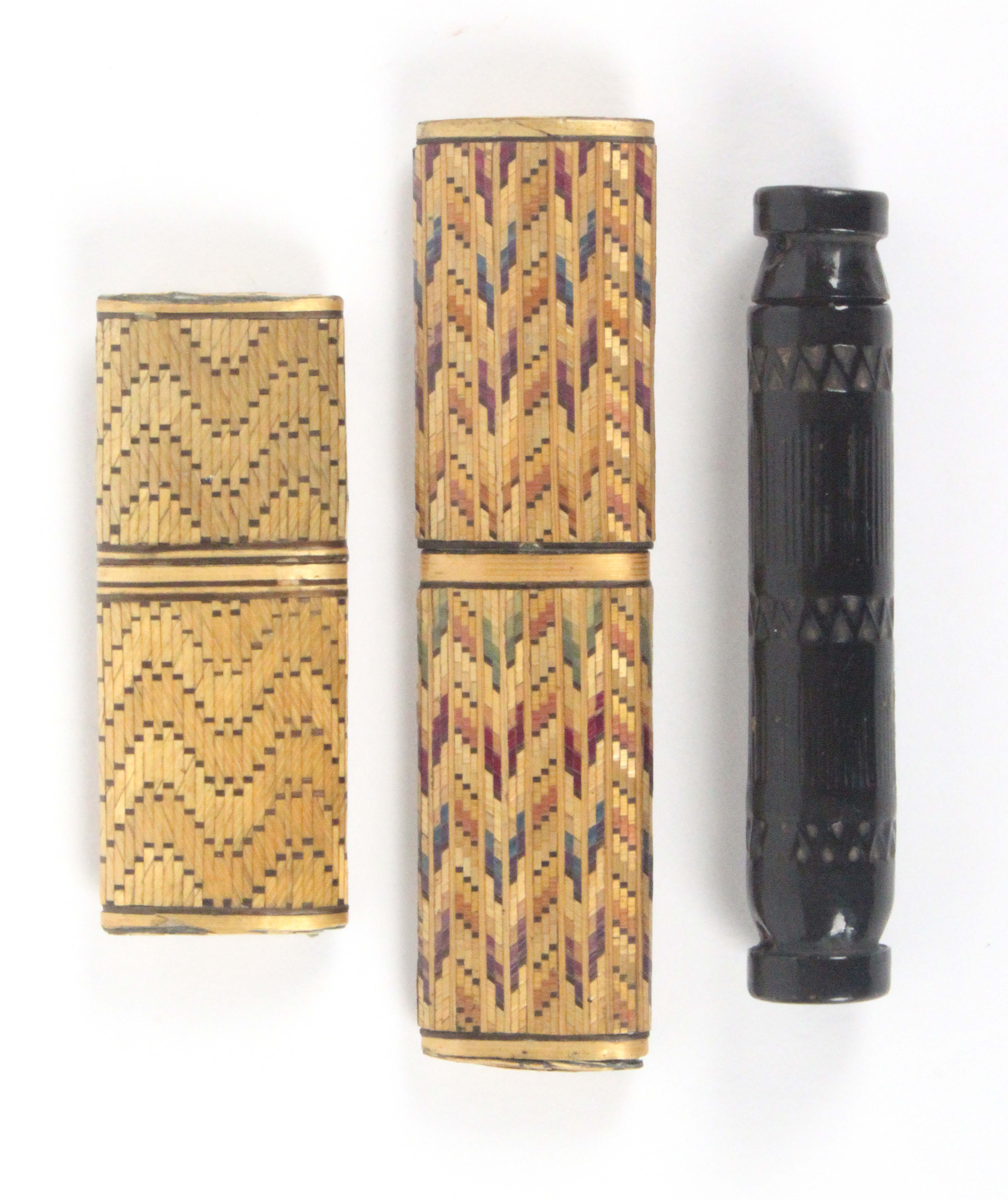 Two straw work needle cases and a wooden example, the straw work examples of oval section covered in
