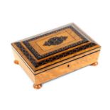 A small birds eye maple Tunbridge ware sewing box, of sarcophagal form and raised on four bun