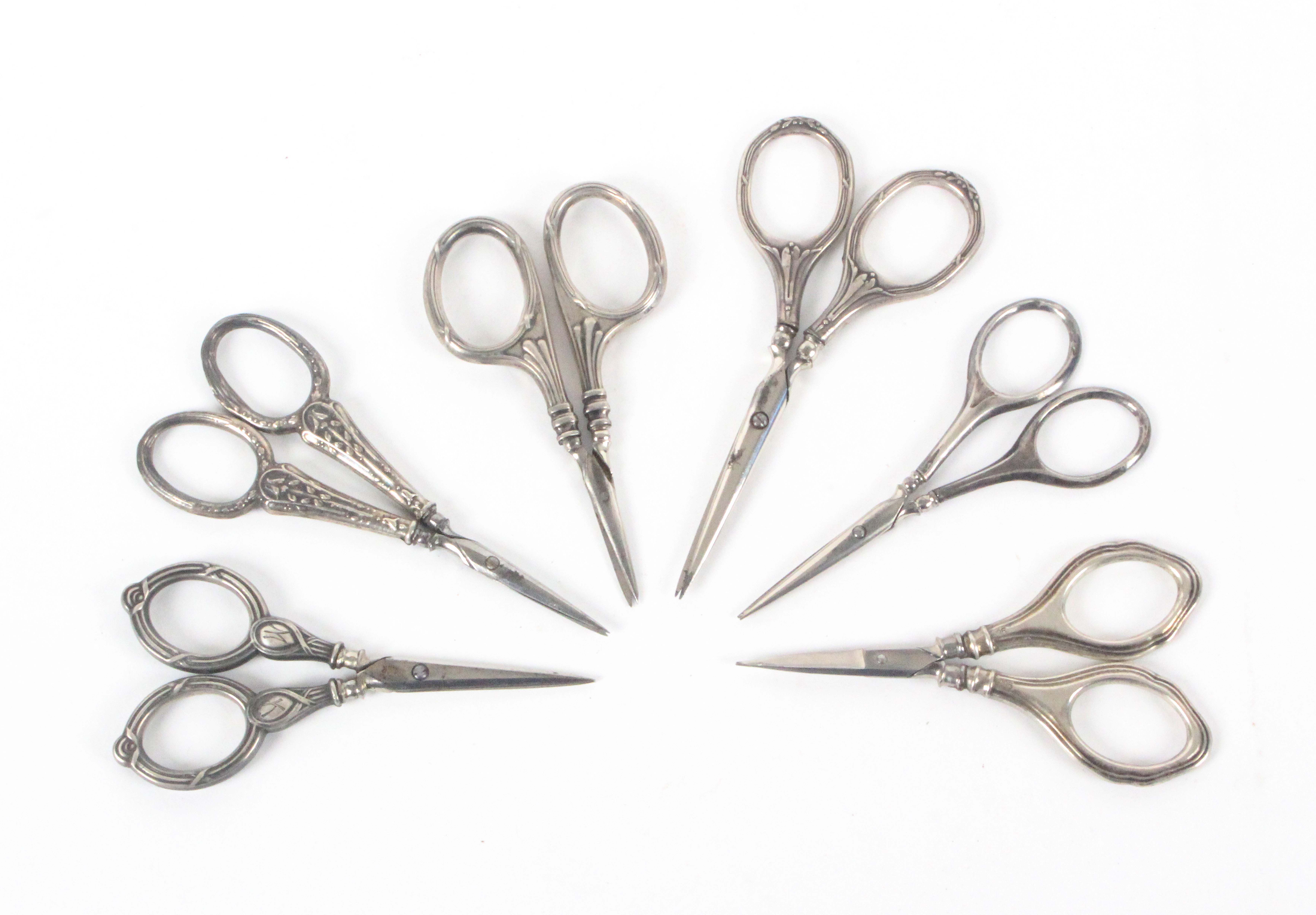 Six pairs of late 19th Century and early 20th Century silver handled continental scissors, all