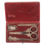 A four piece early Victorian silver sewing set in red leather rectangular case, the lid with