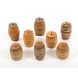 Seven Tunbridge whitewood cotton barrels and a thimble case, the barrels including a line painted