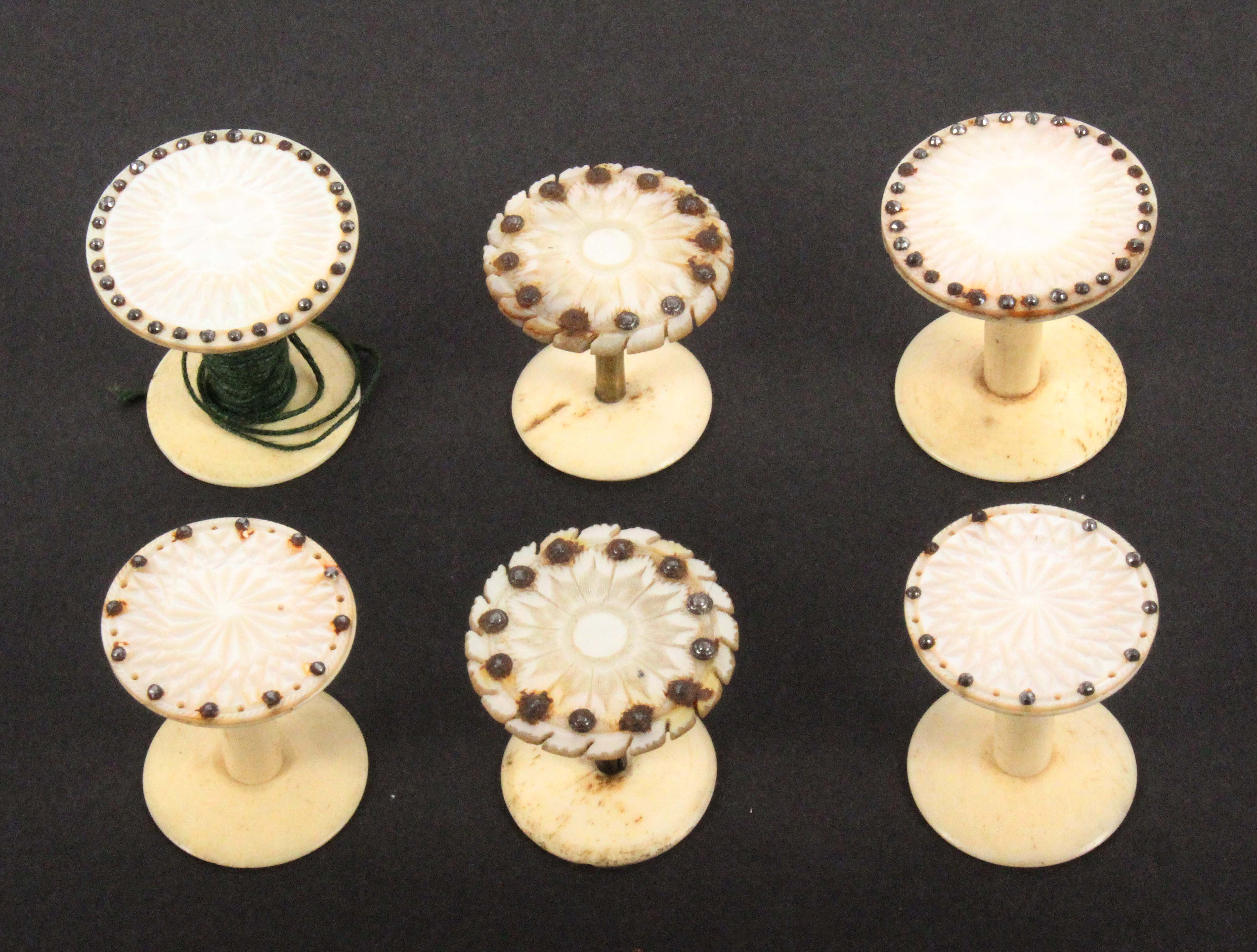 Three pairs of mother of pearl top reels, each pair with cut decoration and embellished with cut