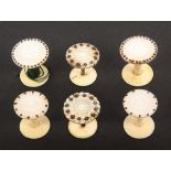 Three pairs of mother of pearl top reels, each pair with cut decoration and embellished with cut