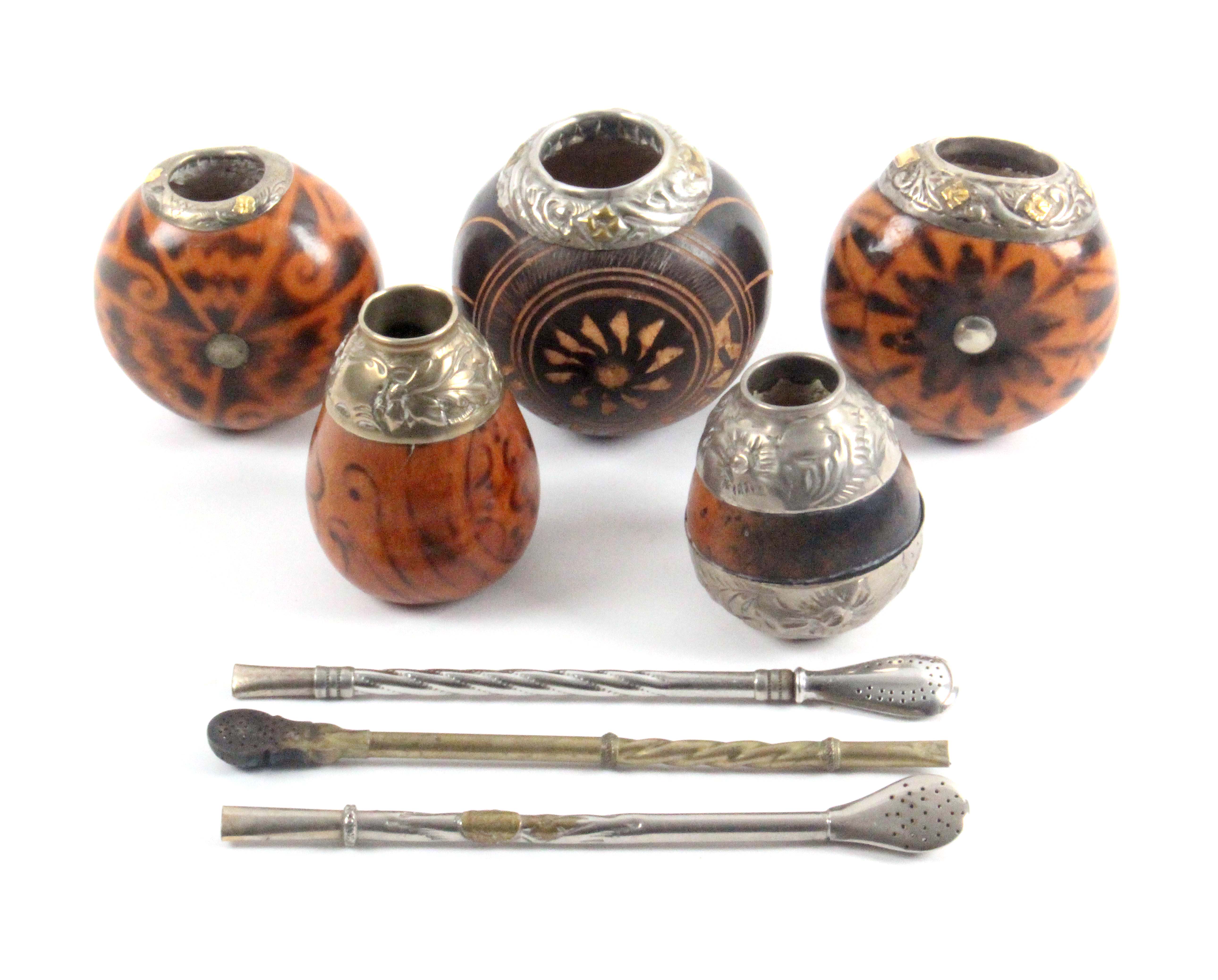 Five Mate gourds, including one inscribed Uruguay, all with decorative metal mounts, and three