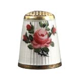 A Norwegian silver gilt and enamel thimble, with a rose spray and single rose on a white enamel