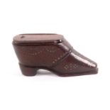 An early 19th Century mahogany shoe form snuff box, the flattened toe below 'S' form brass pique