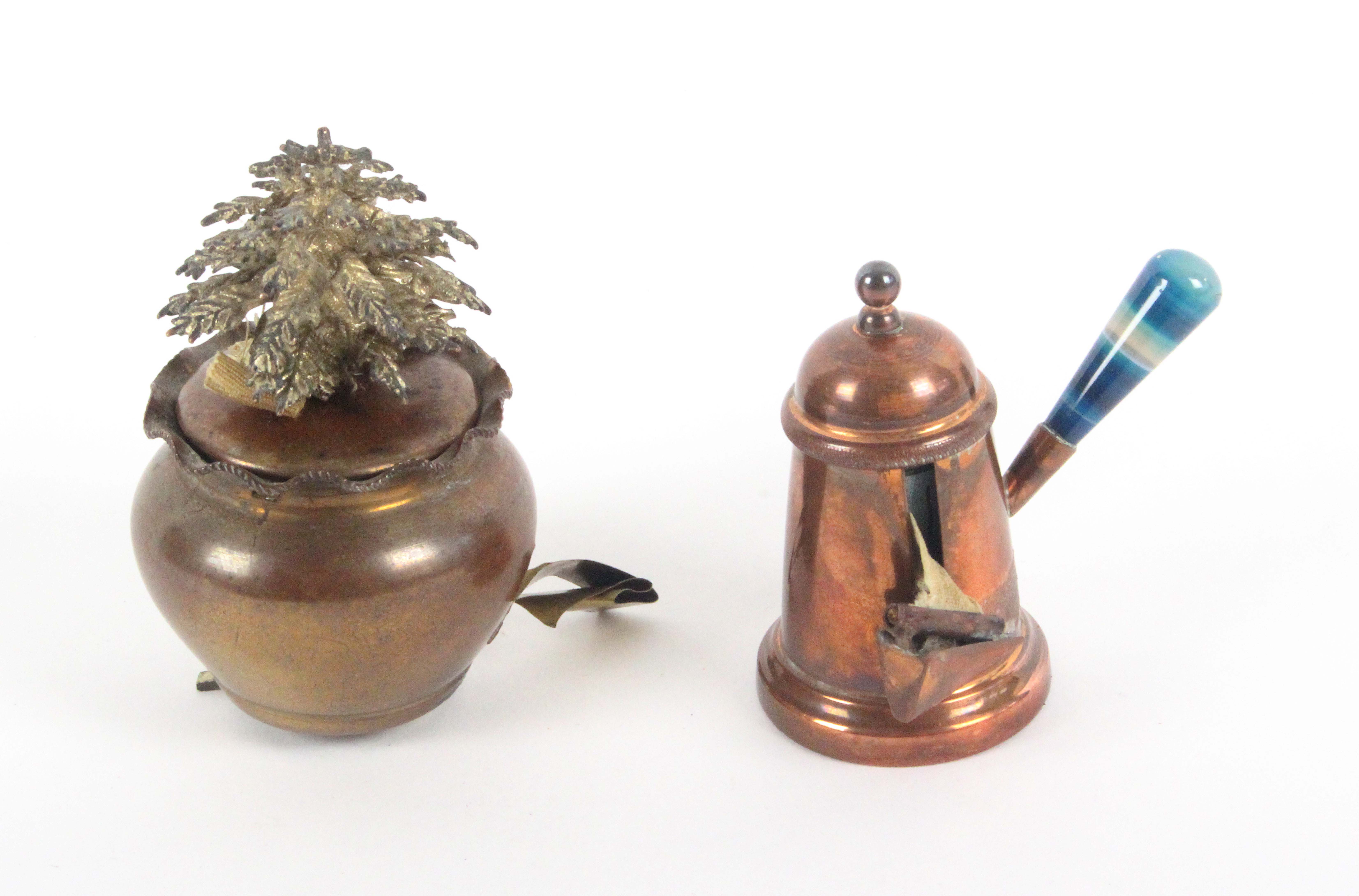 Two copper novelty tape measures, comprising a chocolate pot with agate handle, complete printed