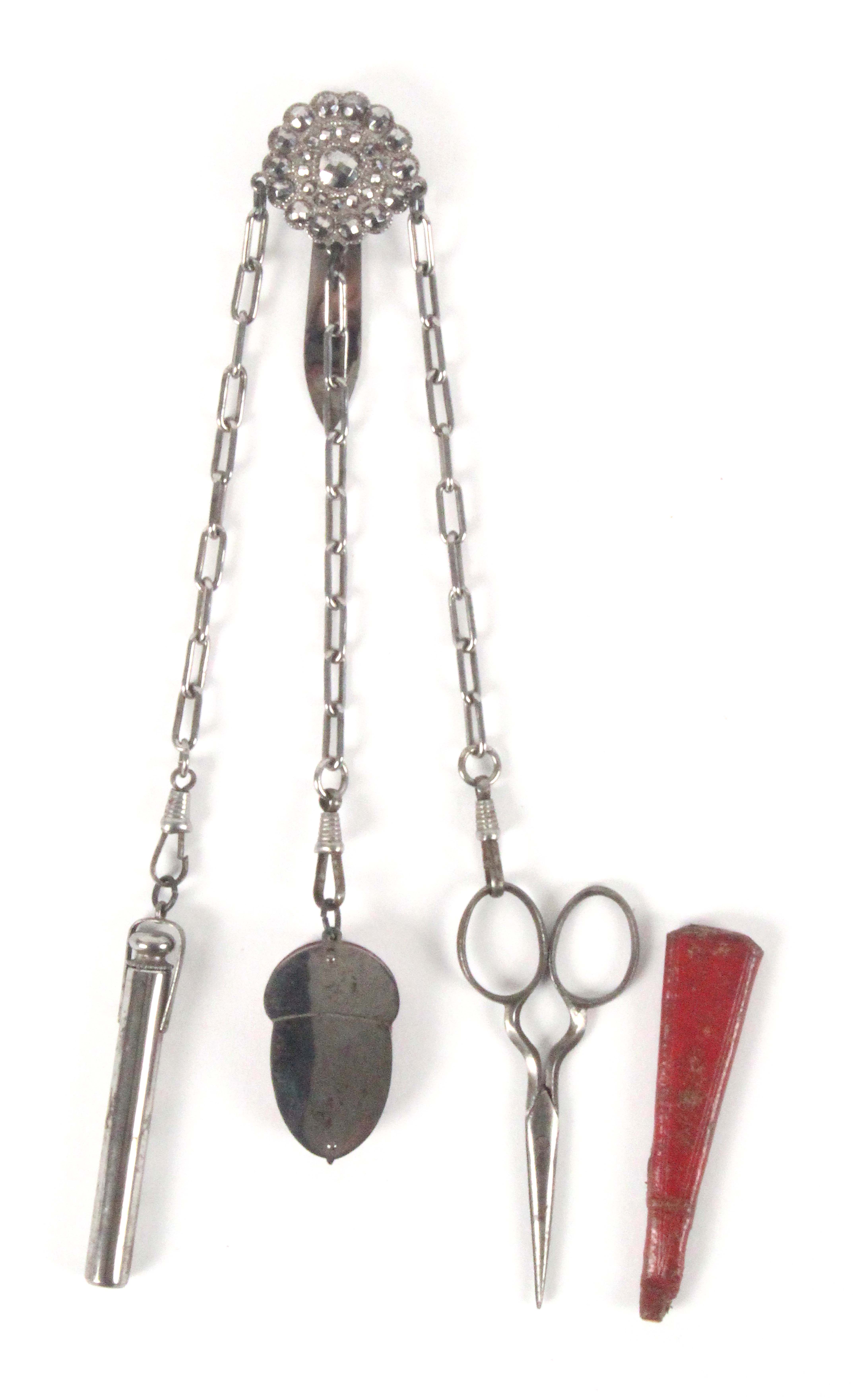 A small attractive early 19th Century cut steel chatelaine, the clip with circular studded boss to