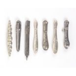 Seven late 19th Century and later continental silver needle cases, all variously decorated,