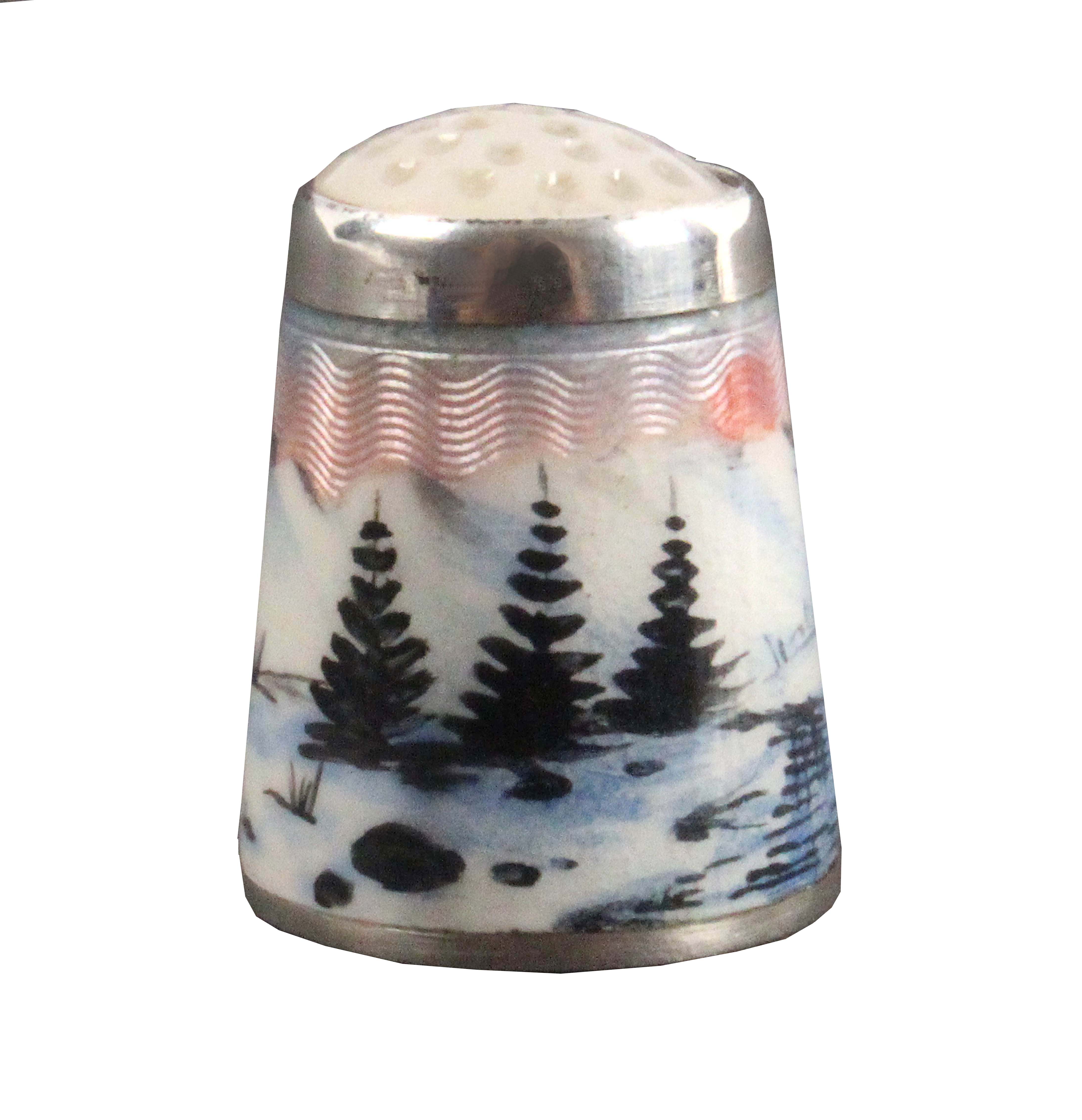 A Norwegian silver and enamel thimble, depicting a river, pine trees, in a snowy mountainous