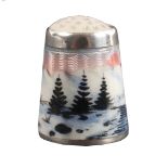 A Norwegian silver and enamel thimble, depicting a river, pine trees, in a snowy mountainous