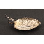 A silver caddy spoon, the leaf shaped and decorated bowl with the handle formed as an encircled