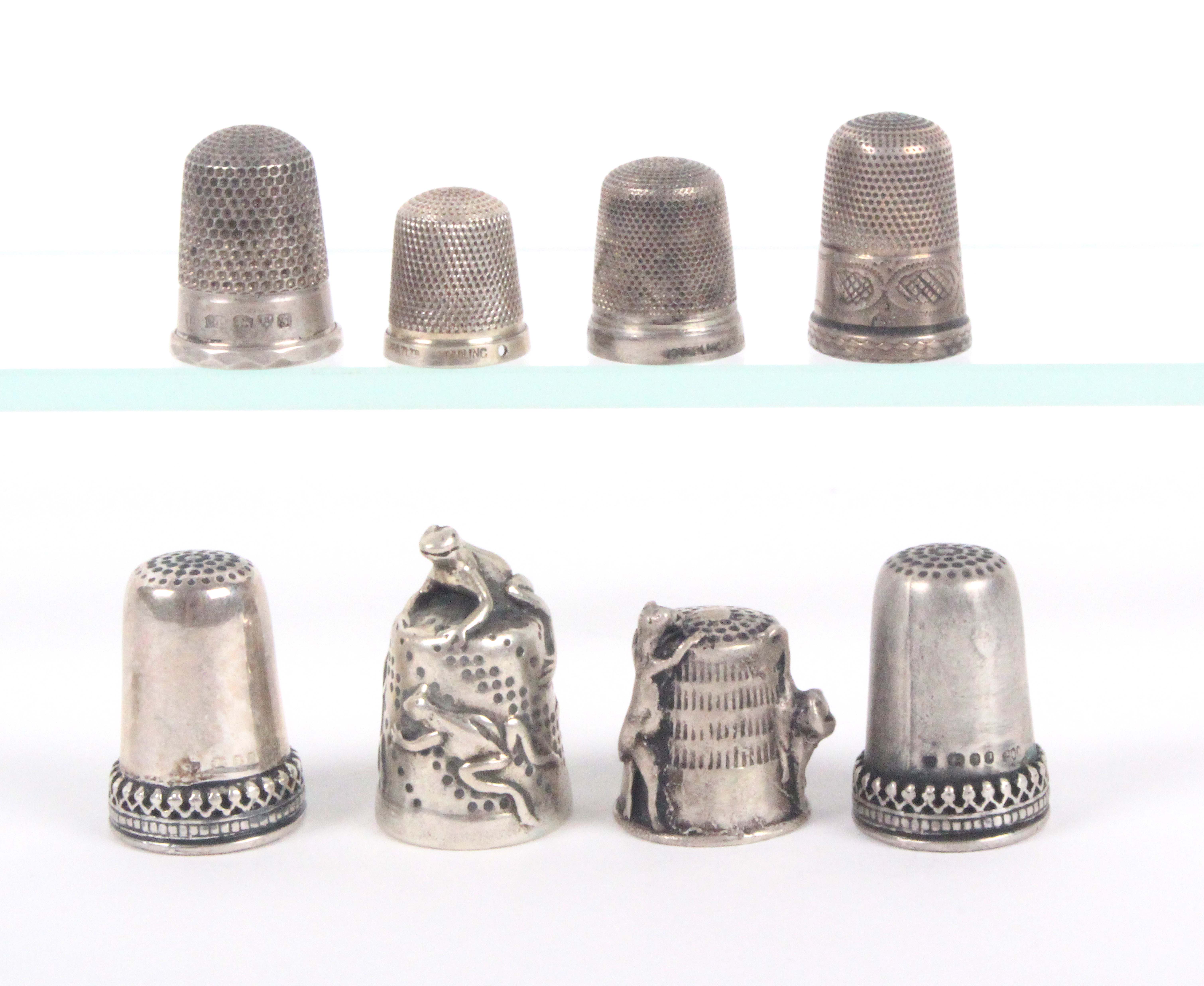 Eight 19th Century and later decorative silver thimbles, most with British hallmarks.    (8)