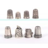 Eight 19th Century and later decorative silver thimbles, most with British hallmarks.    (8)