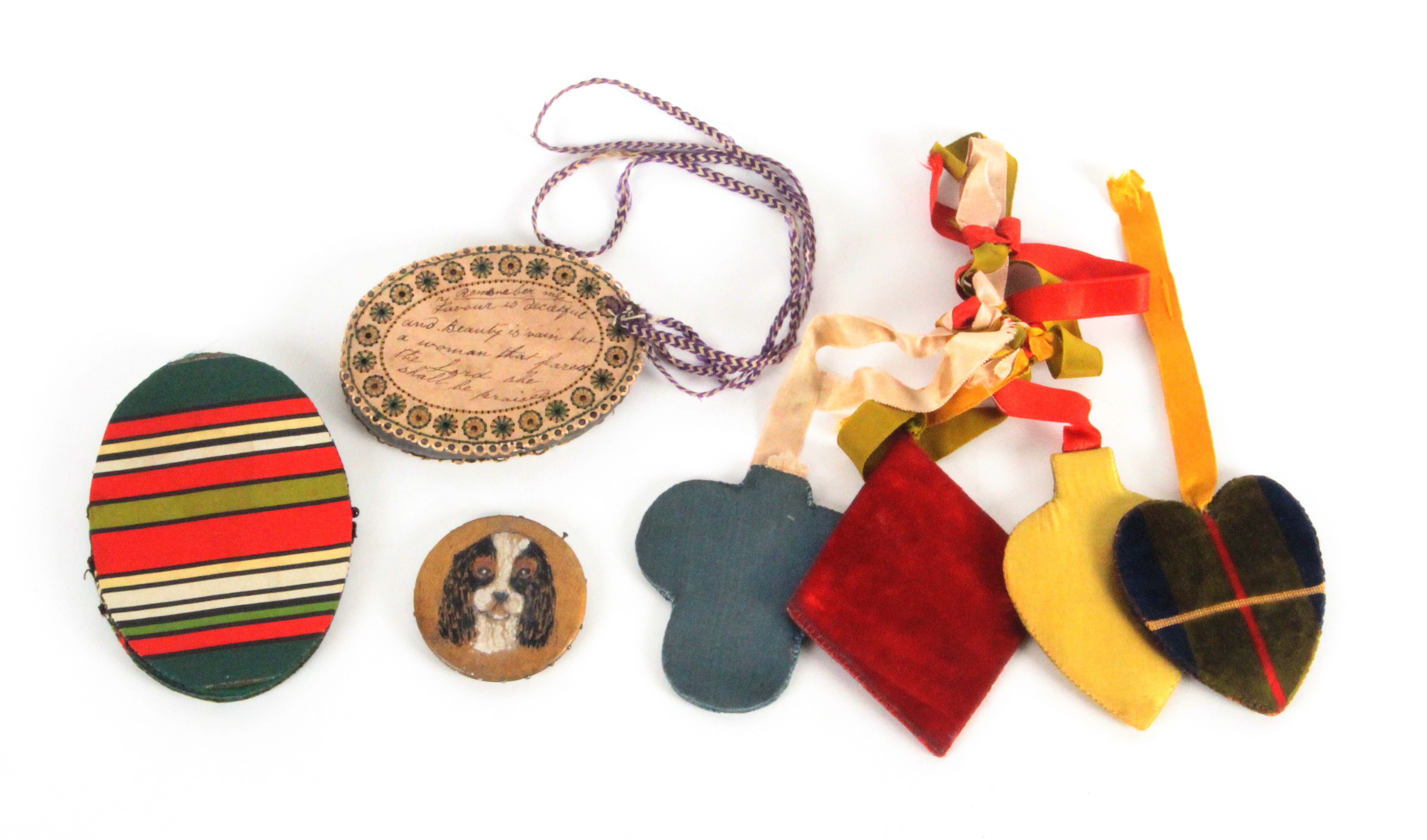 Pin cushions and a needle book, comprising an embroidered and ink inscribed oval pin cushion '