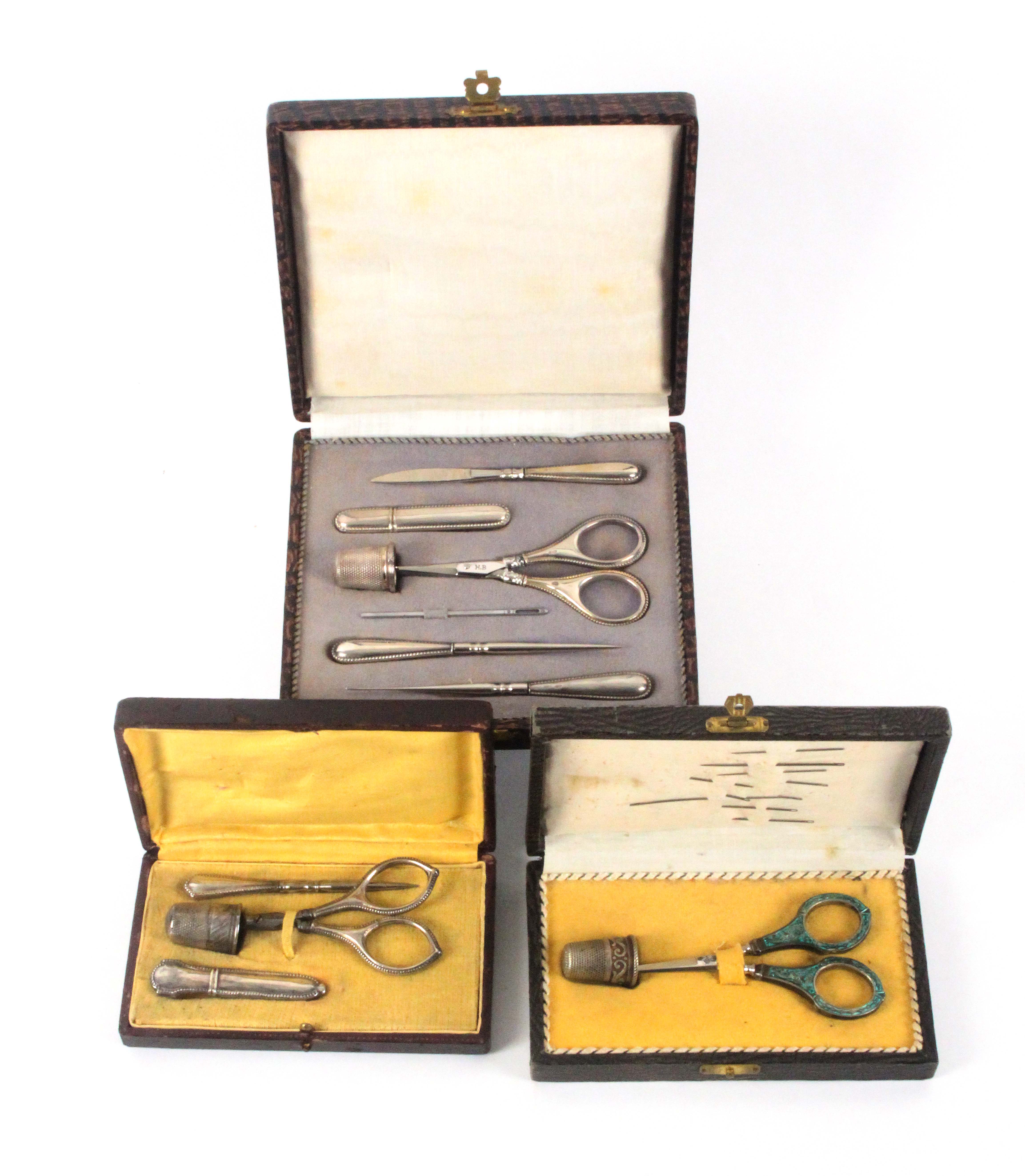 Three continental sewing sets, all in rectangular leatherette cases comprising an example with