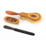Tunbridge ware - three pieces, comprising a satinwood guitar shaped brush with a geometric mosaic