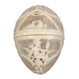 A very fine early 19th Century carved and pierced ivory thimble egg, the trellis pierced ground with