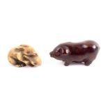 Two Japanese netsuke late 19th/early 20th Century, comprising a wooden example in the form of a pig,