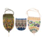 Three 19th Century beadwork draw string bags, two decorated with flowers the other with geometric