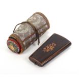 A French rosewood etui and a decorative sewing roll, the rosewood etui of tapering form and oval