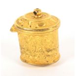 A late 18th Century gilded metal thimble case for a chatelaine, of oval form decorated with leaves