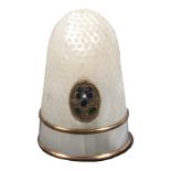 A good Palais Royal mother of pearl thimble, inset with an oval gilt and enamel pansy motif over two