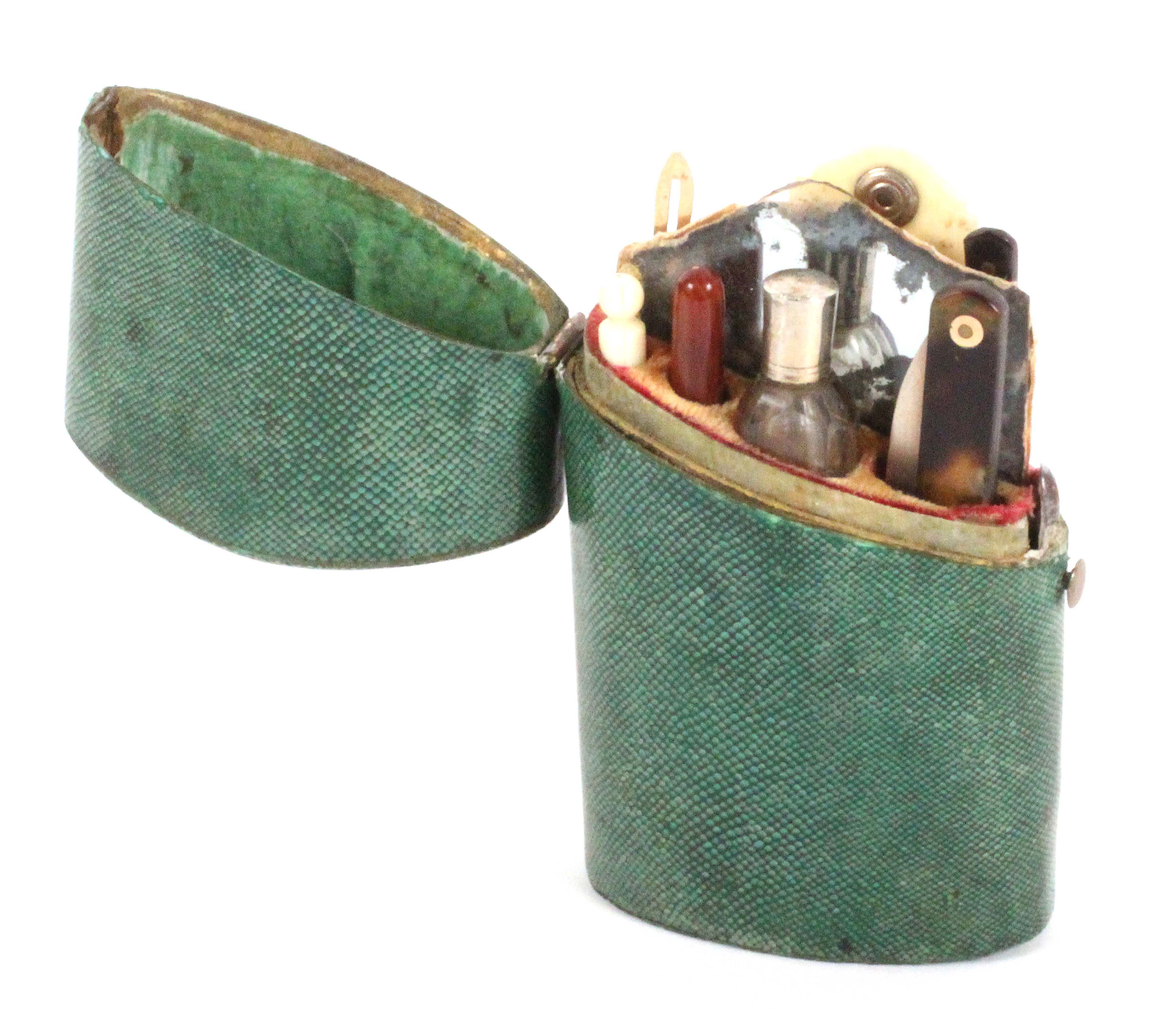 A late 18th Century green shagreen etui, the case of oval section and slightly tapering, hinged